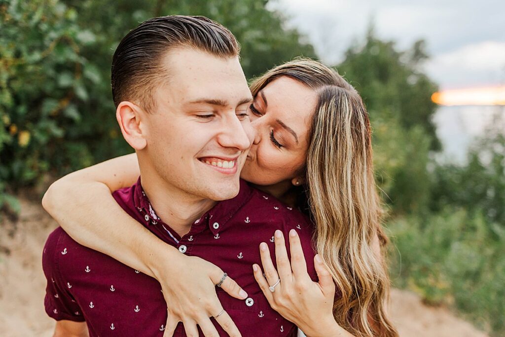 Couple embracing after a surprise proposal in Northern Michigan
