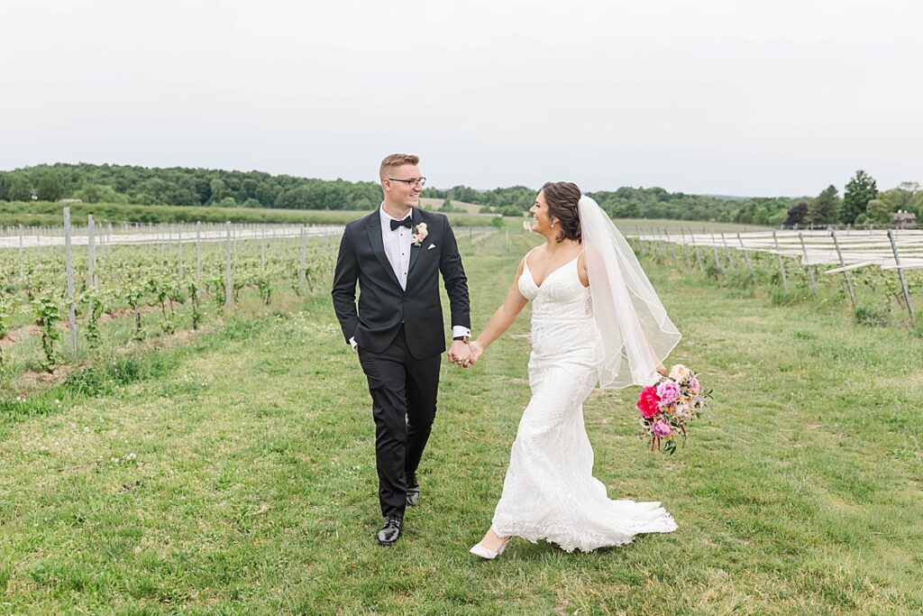 Newlyweds laughing together during portraits on a Northern Michigan wedding day