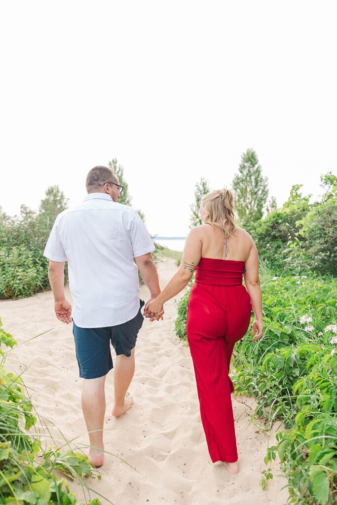 Natural engagement photos in Northern Michigan with soft shade and greenery