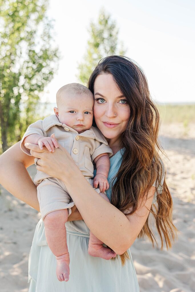 Mother and newborn sharing a quiet moment by the water in Elk Rapids