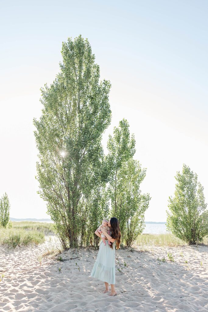 New mom holding her baby during a relaxed Northern Michigan session