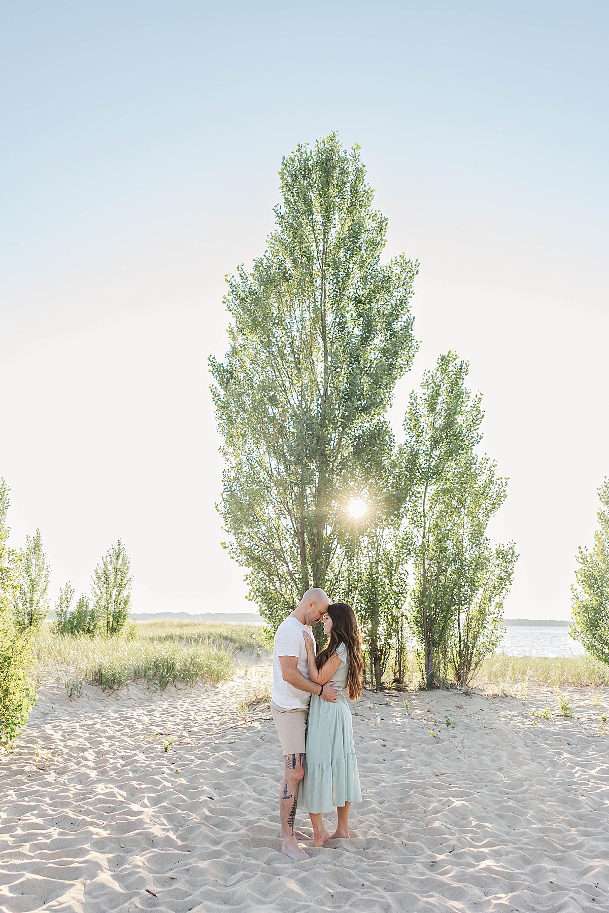 Family cuddling together during an Elk Rapids family session at Dam Beach in Northern Michigan