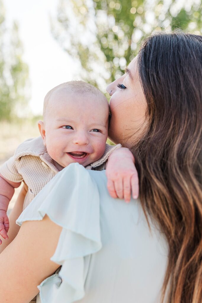 Mom cuddling her newborn at Dam Beach in Elk Rapids