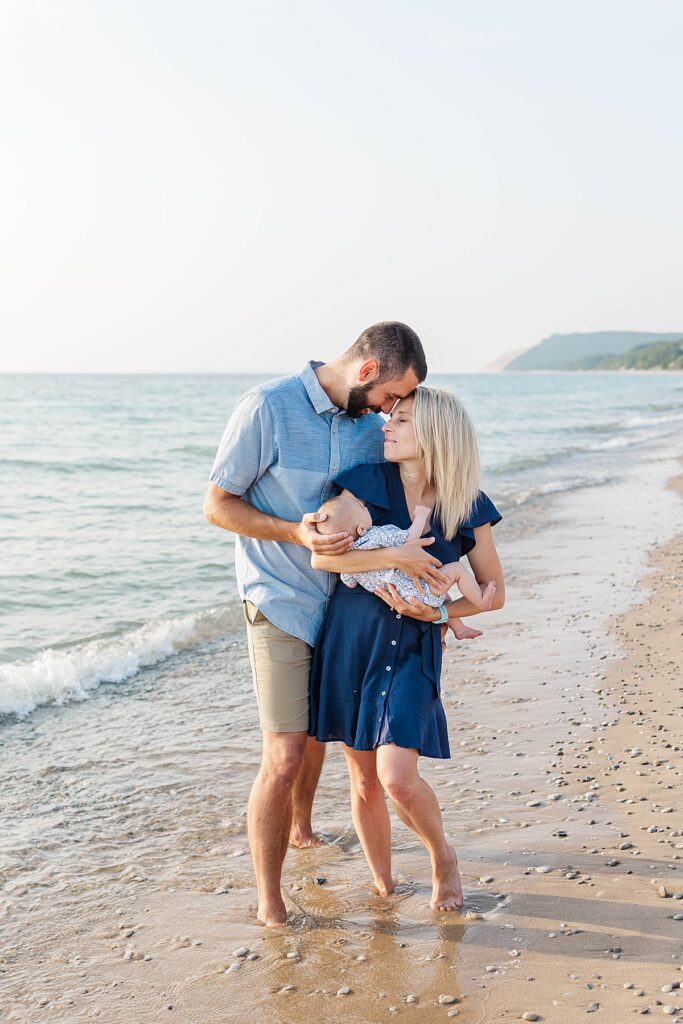Family holding their newborn during an Empire Beach family session