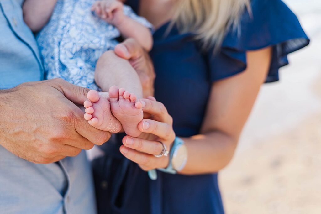 Tender family moment with newborn at Empire Beach