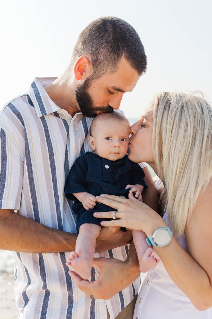 Family holding their newborn during an Empire Beach family session