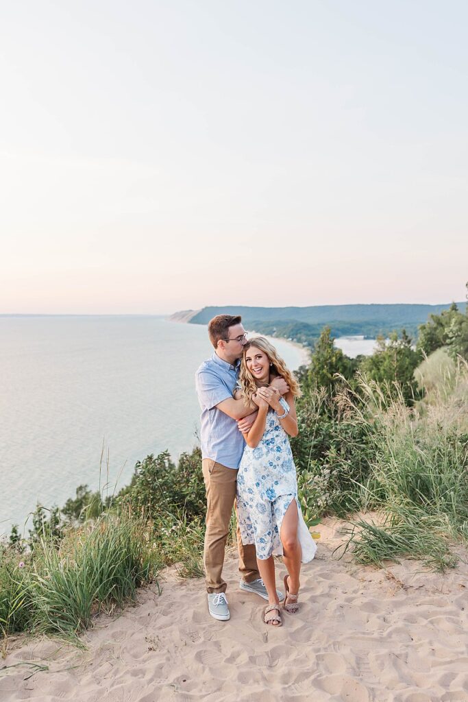 Couple standing at Empire Bluff overlook during engagement session
