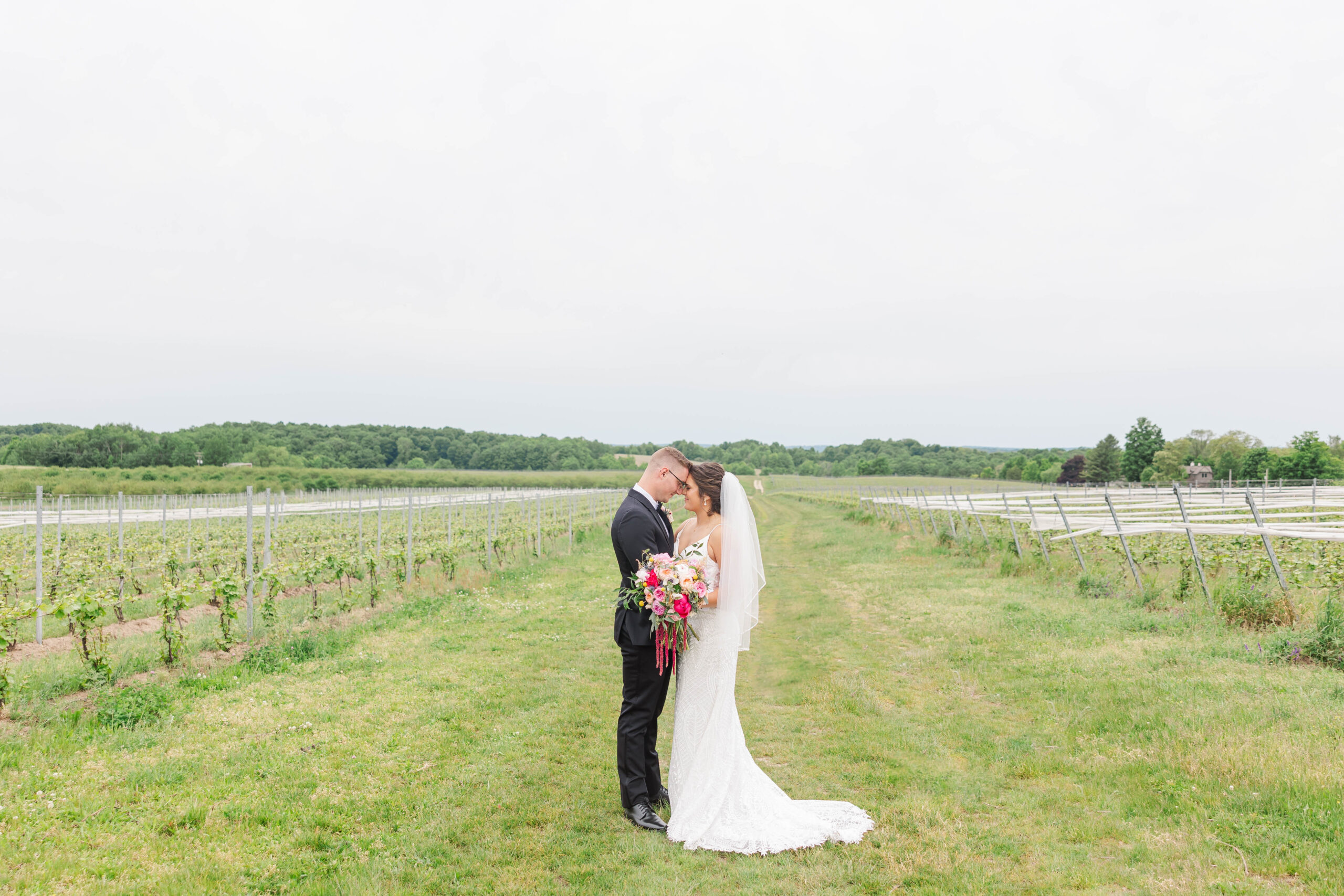 Bride and groom sharing a quiet moment in a vineyard on their wedding day near Traverse City, Michigan