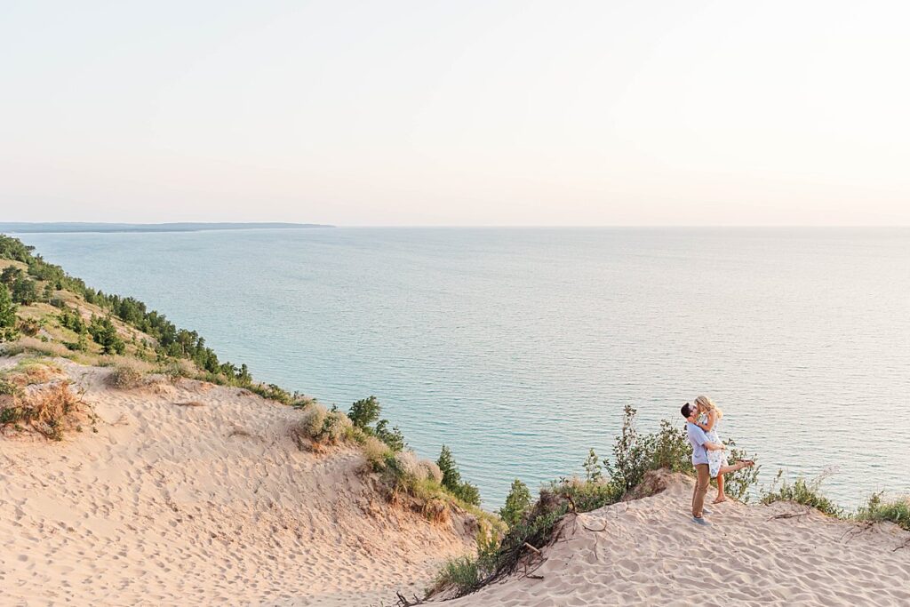 Couple standing at Empire Bluff overlook during engagement session