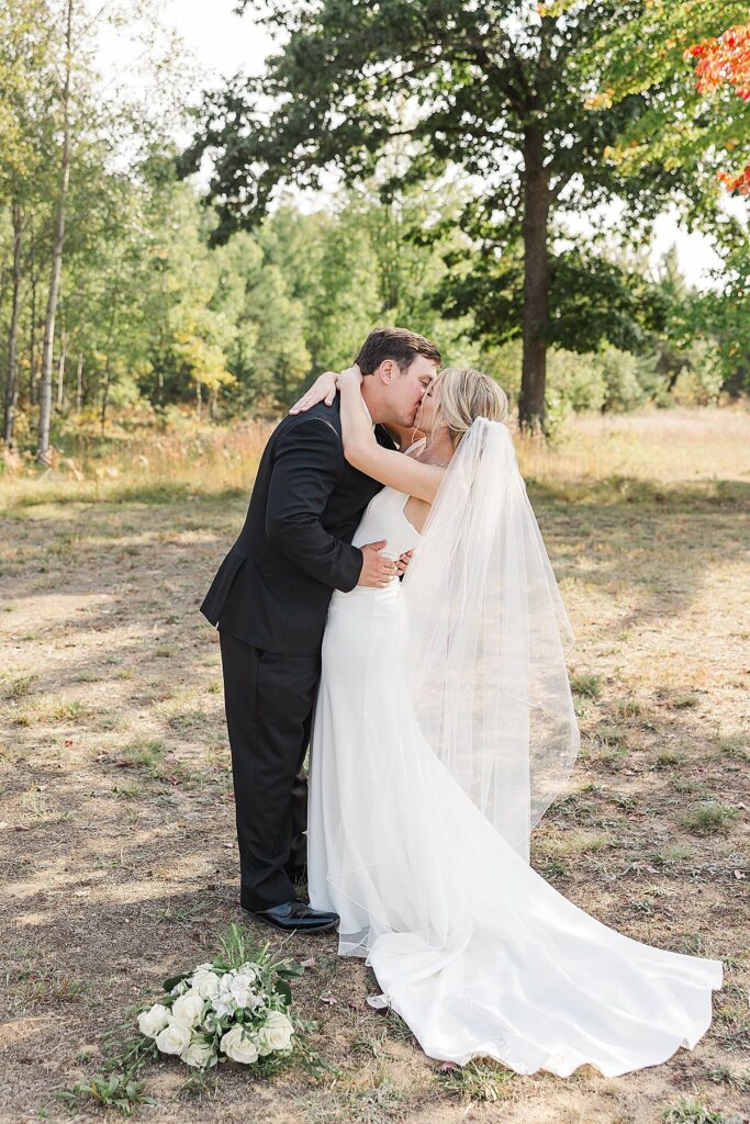 Bride and groom sharing a quiet moment during fall wedding portraits in Northern Michigan