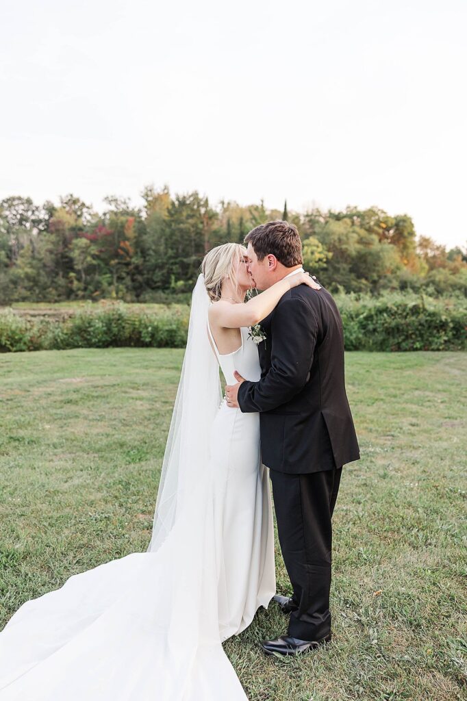 Sunset portraits of bride and groom near the pond at Mill Pond Event Center