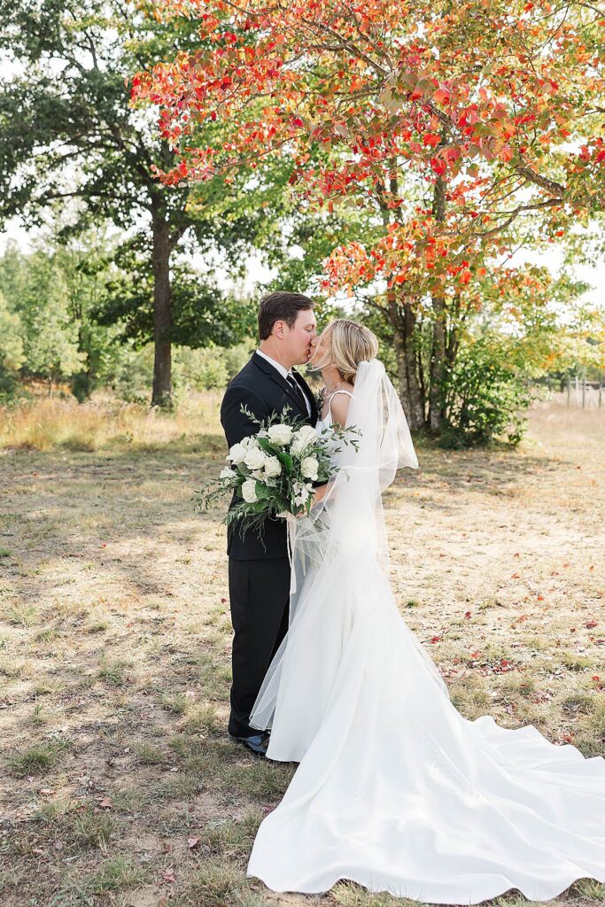 Bride and groom surrounded by fall colors during Northern Michigan wedding portraits
