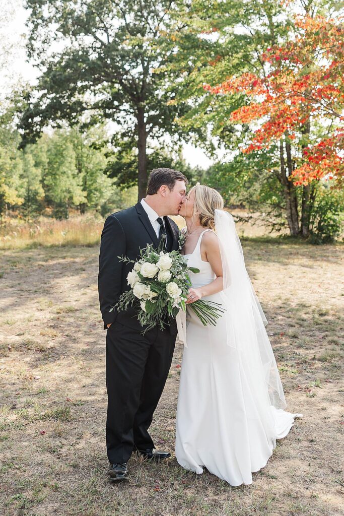 Bride and groom sharing a quiet moment during fall wedding portraits in Northern Michigan