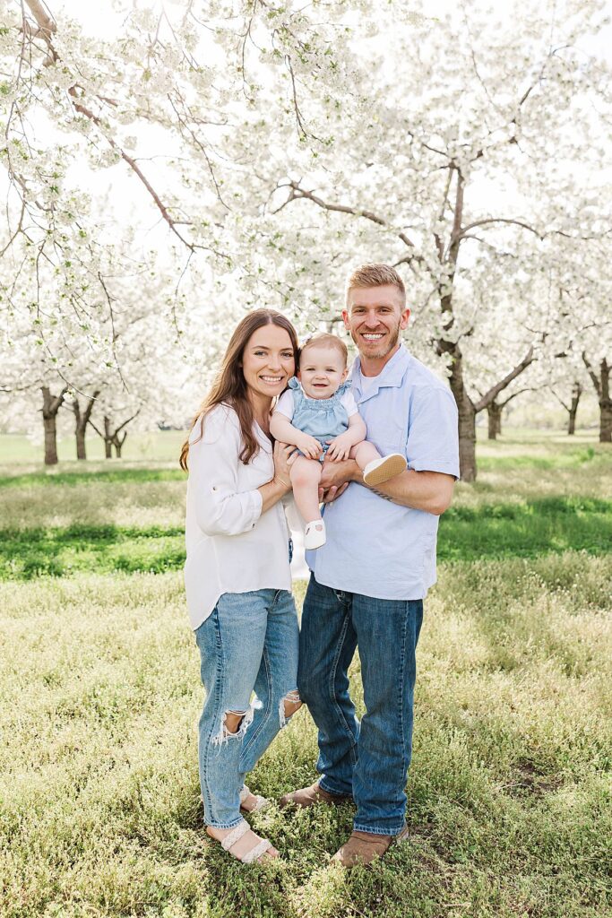 Family celebrating their daughter turning one during cherry blossom season