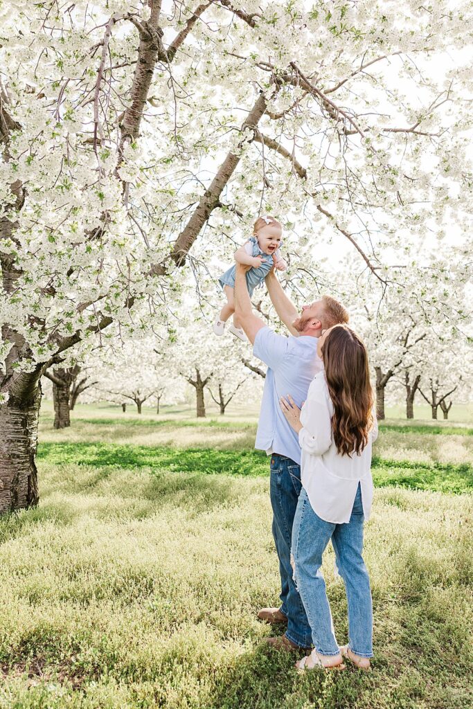 Parents holding their baby daughter during a spring family session