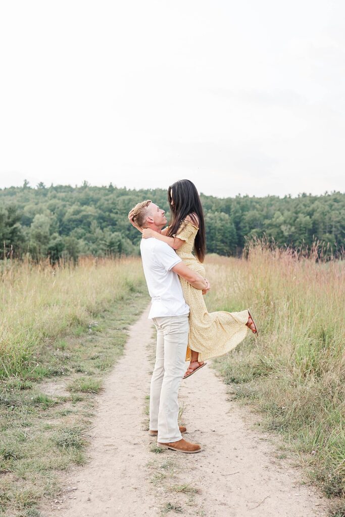 Candid Northern Michigan engagement session filled with laughter and genuine emotion.