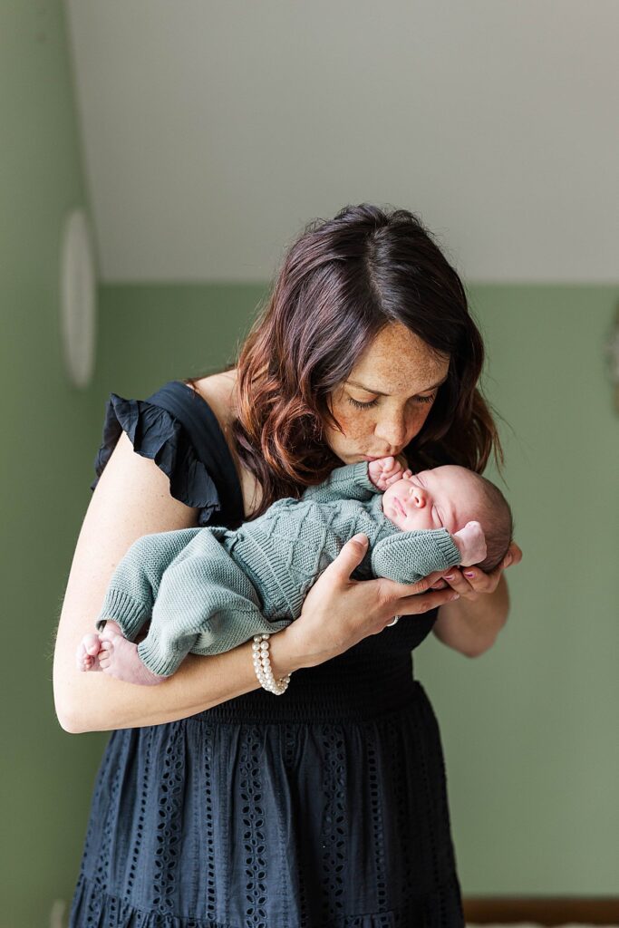Mother and newborn photographed in soft natural light