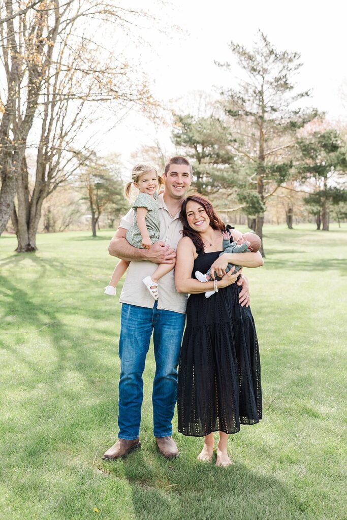 Parents holding their newborn during a Northern Michigan newborn session
