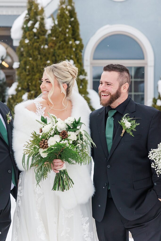 Bride and groom sharing a candid moment during their winter wedding day