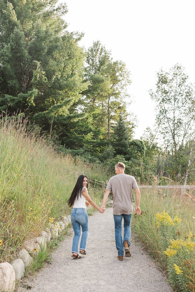 Playful engagement photo of a couple laughing together during a Northern Michigan engagement session.