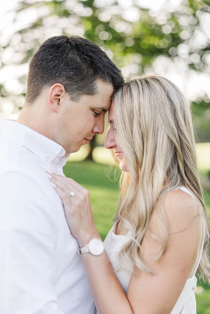 Engagement photos among tall trees on a family property in Michigan