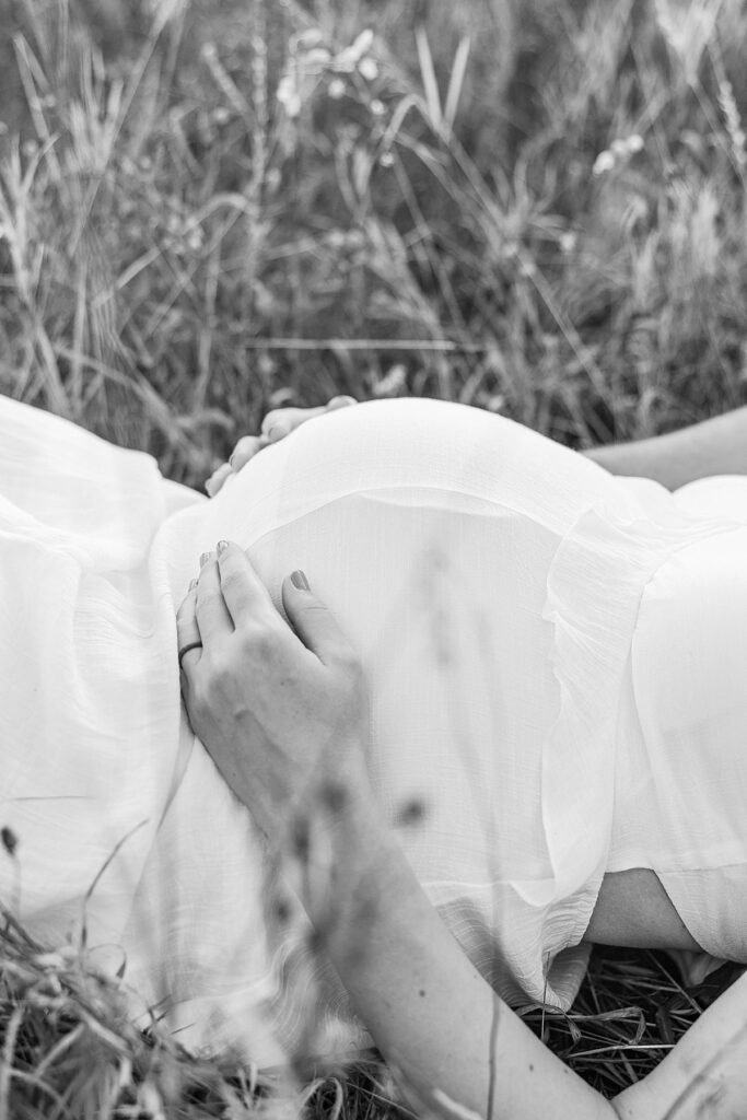 Expecting mom holding her baby bump during a Traverse City maternity session