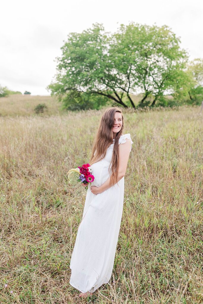 Sweet maternity portrait highlighting baby bump in a garden setting