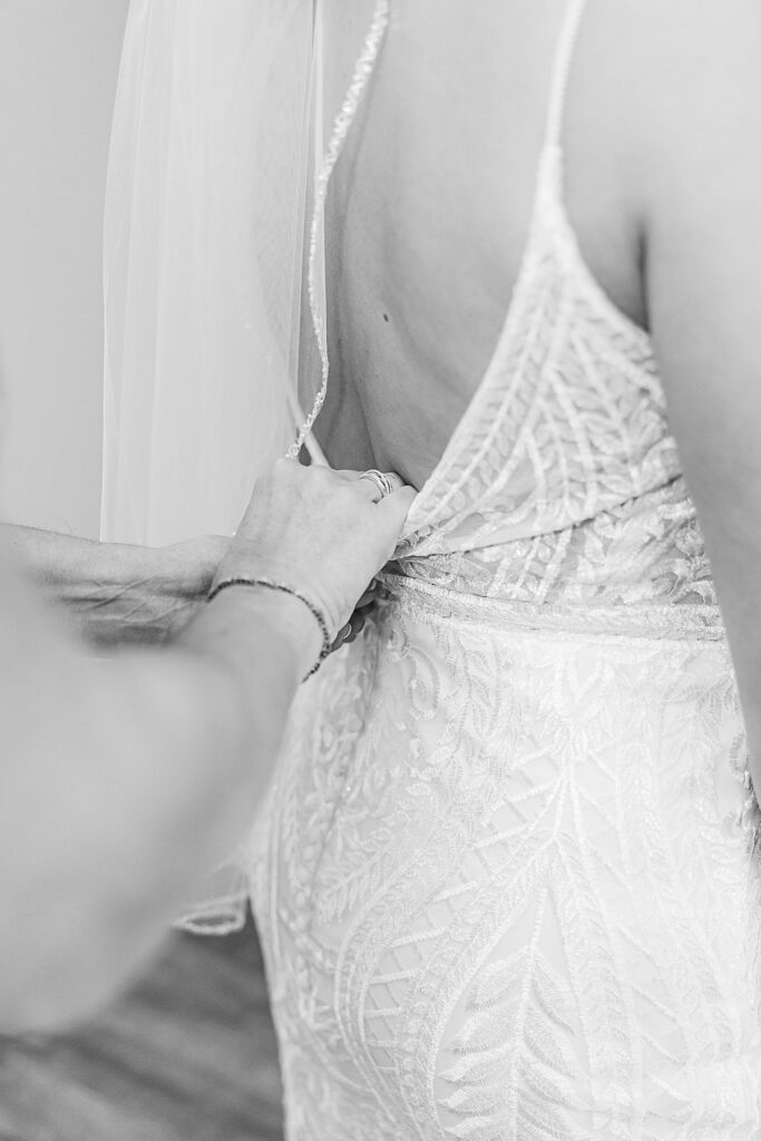 Mother of the bride buttoning wedding dress at BlueBridge Events Center