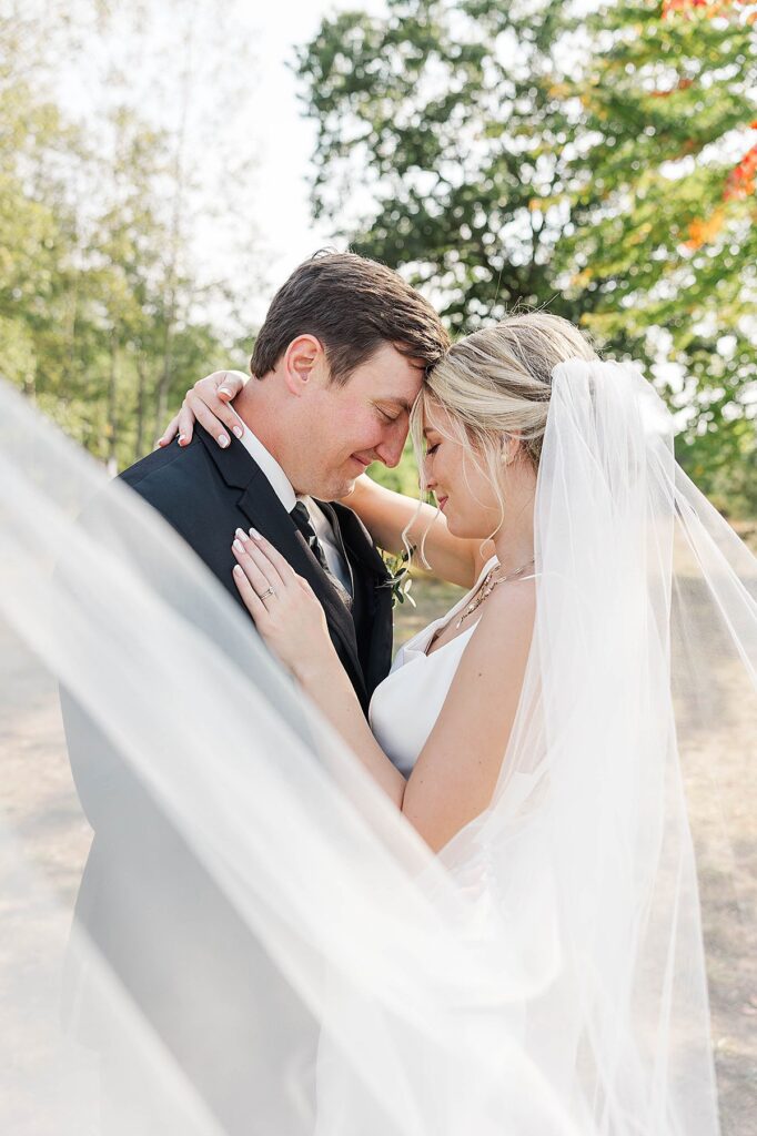 Romantic Northern Michigan wedding portrait with soft veil movement in Traverse City