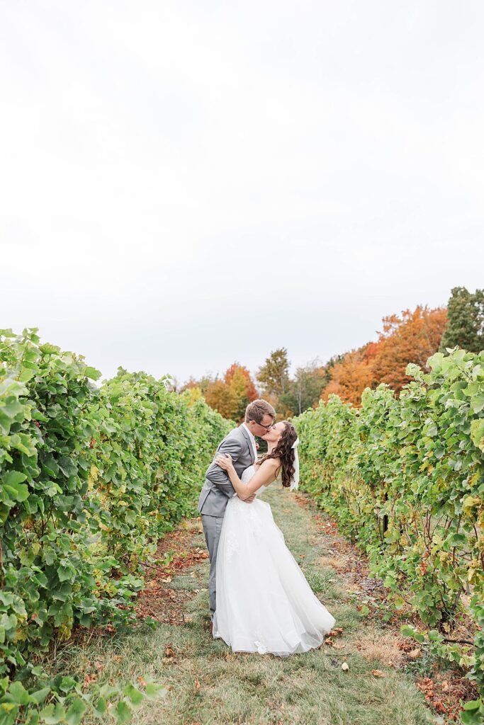 Bride and groom in vineyard during a Traverse City wedding on Old Mission Peninsula in fall
