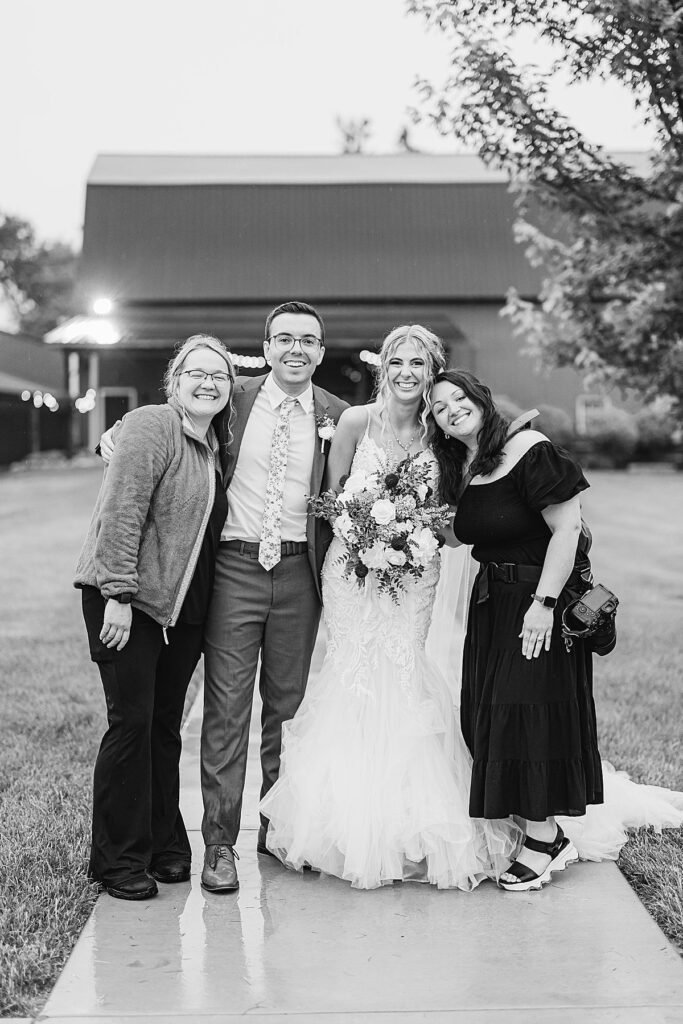 Wedding photographer and second photographer celebrating with the couple at the end of the night during a joyful wedding day