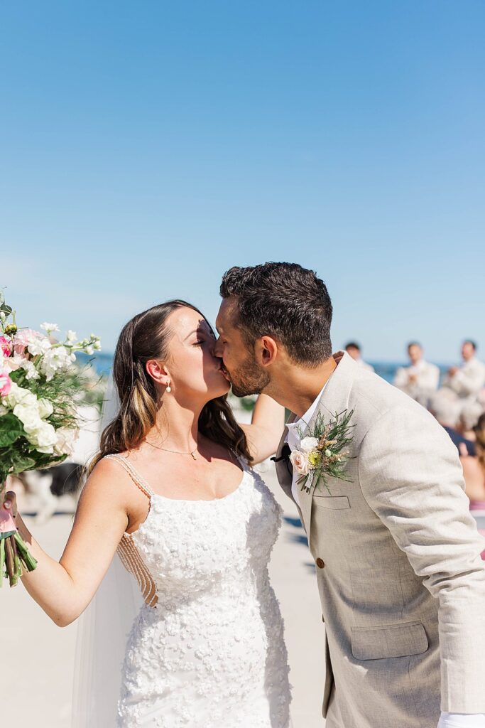Newlyweds kissing during their Bayview wedding ceremony at Gallagher Farms in Northern Michigan