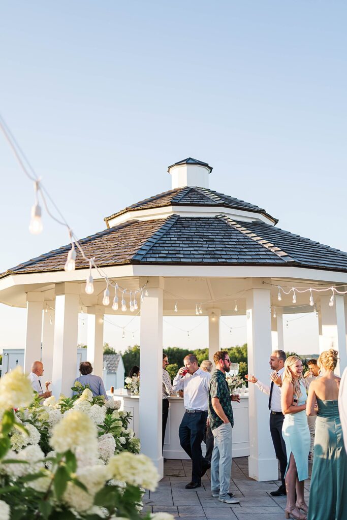 Guests enjoying cocktail hour at the pavilion during a Bayview wedding at Gallagher Farms