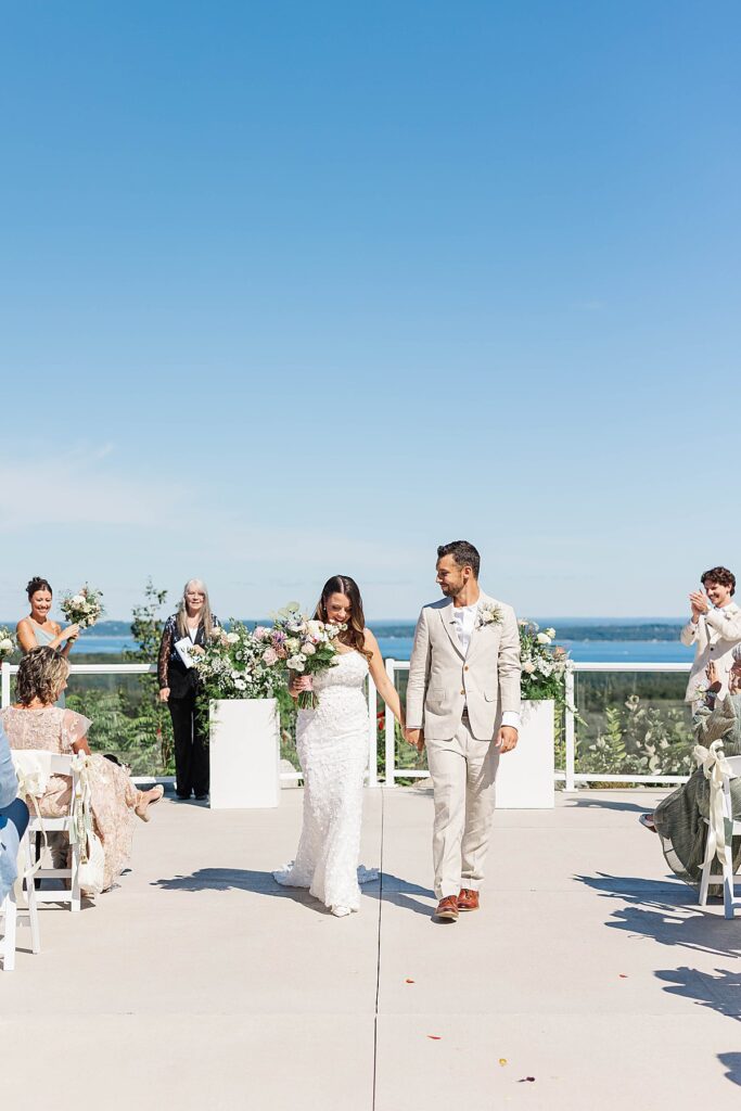 Bride and groom saying vows overlooking West Grand Traverse Bay