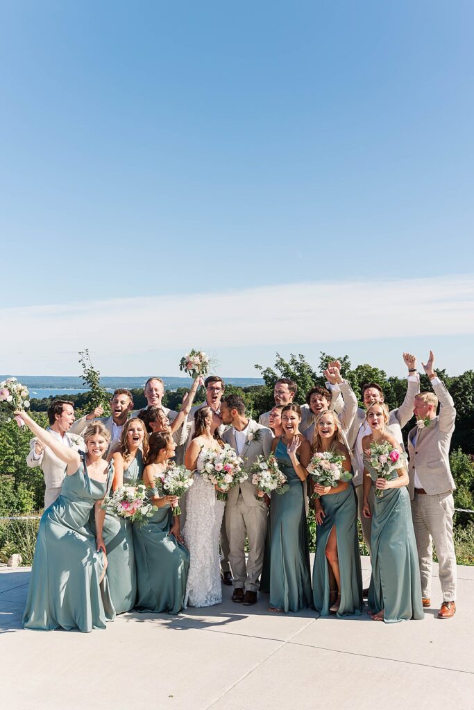 Joyful bridal party portraits in Northern Michigan orchard