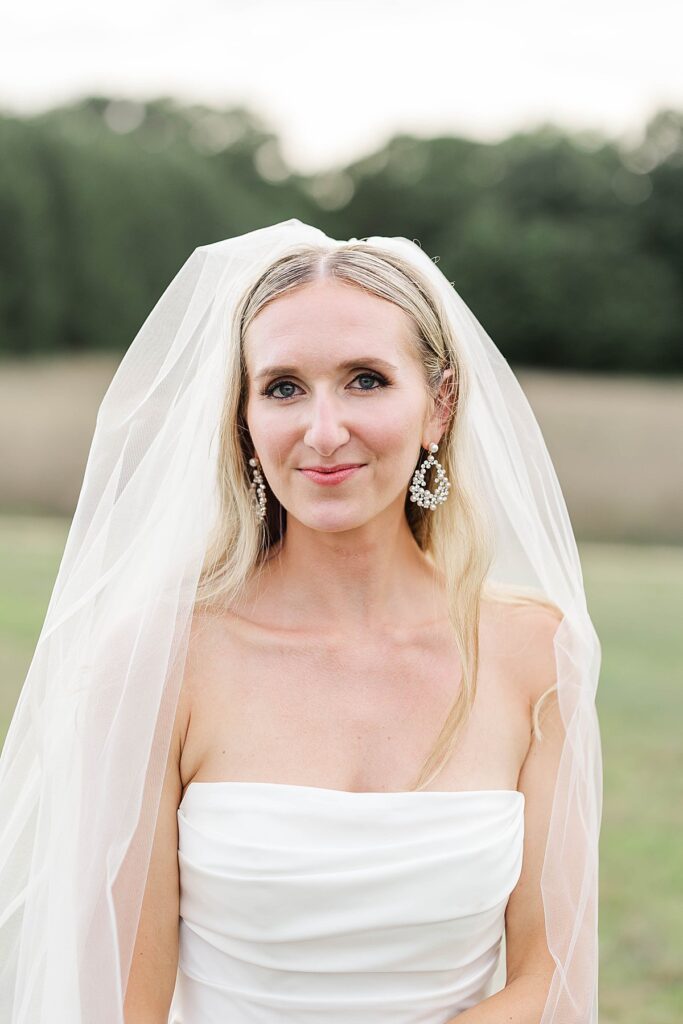 Editorial bridal portrait with soft veil movement at Heritage Wedding Barns