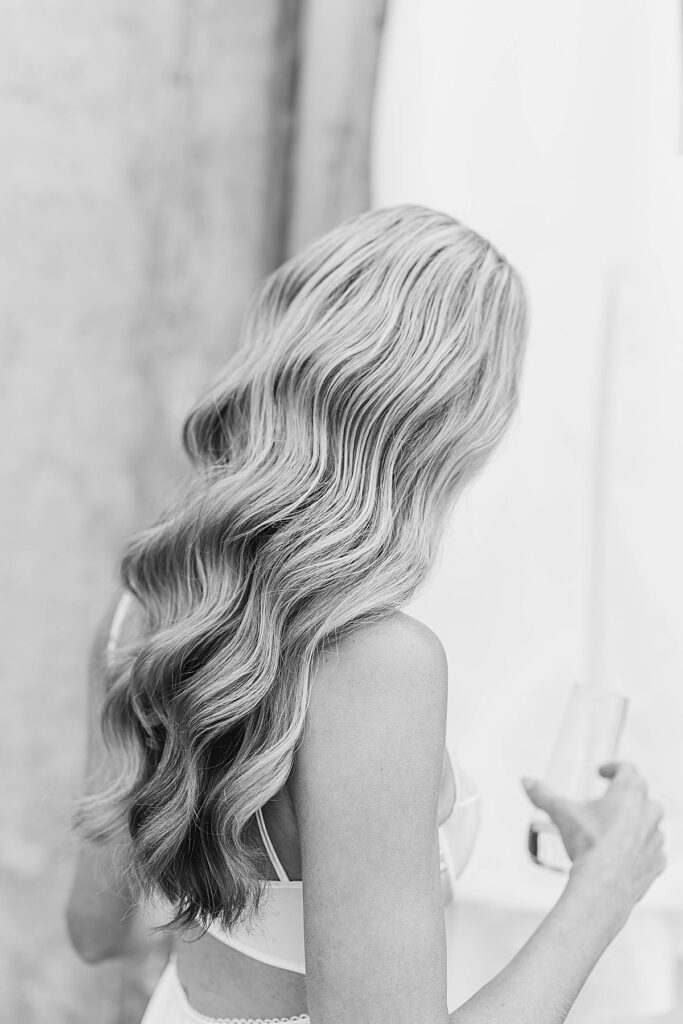 Bride standing near her wedding dress before getting ready at Heritage Wedding Barns