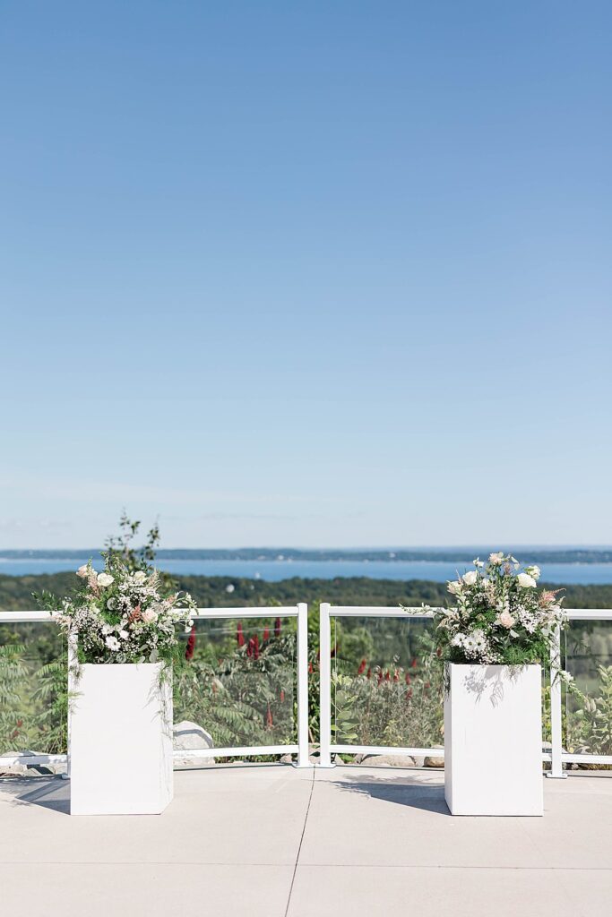 Ceremony overlook with floral arch overlooking Grand Traverse Bay at Bayview Weddings at Gallagher Farms