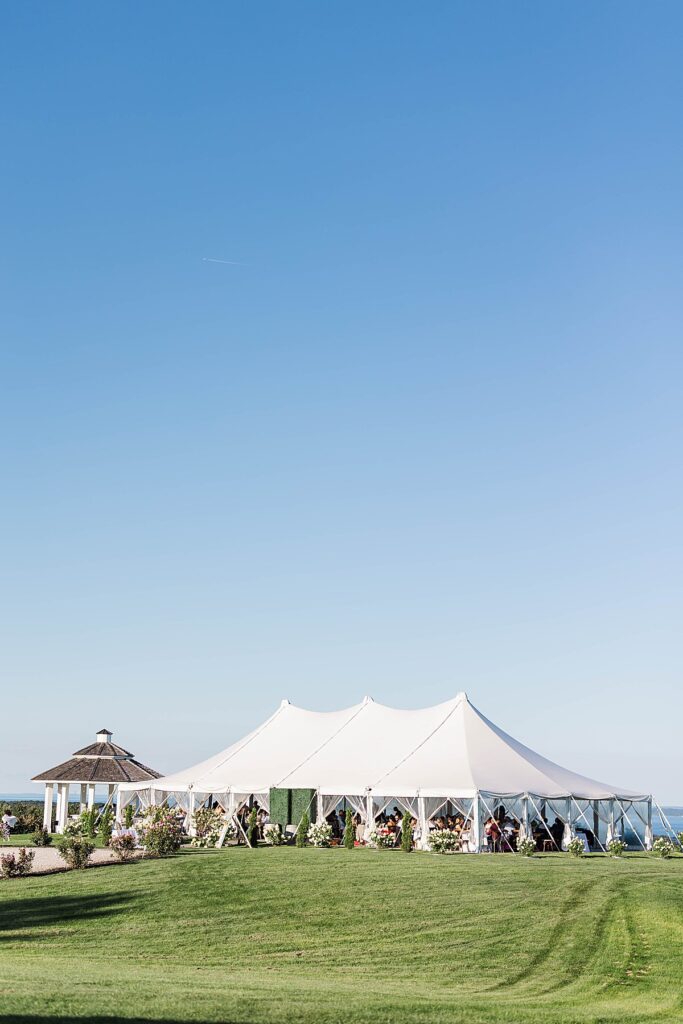 White tent reception space at Bayview Weddings at Gallagher Farms with vineyard and orchard views