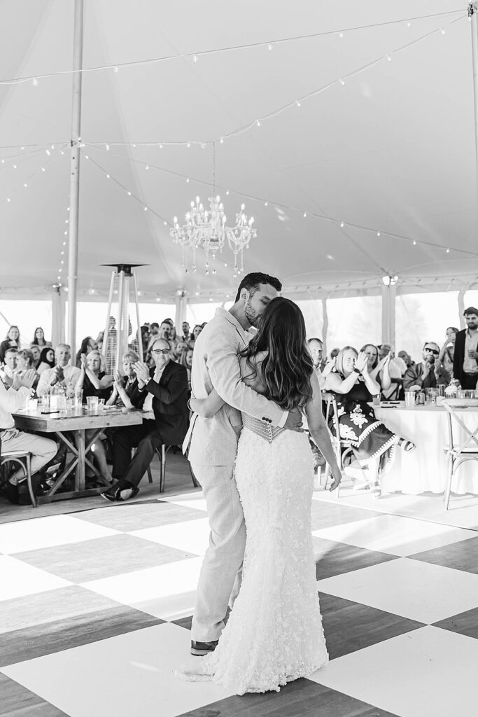 Black and white first dance on checkered dance floor at Bayview Weddings at Gallagher Farms