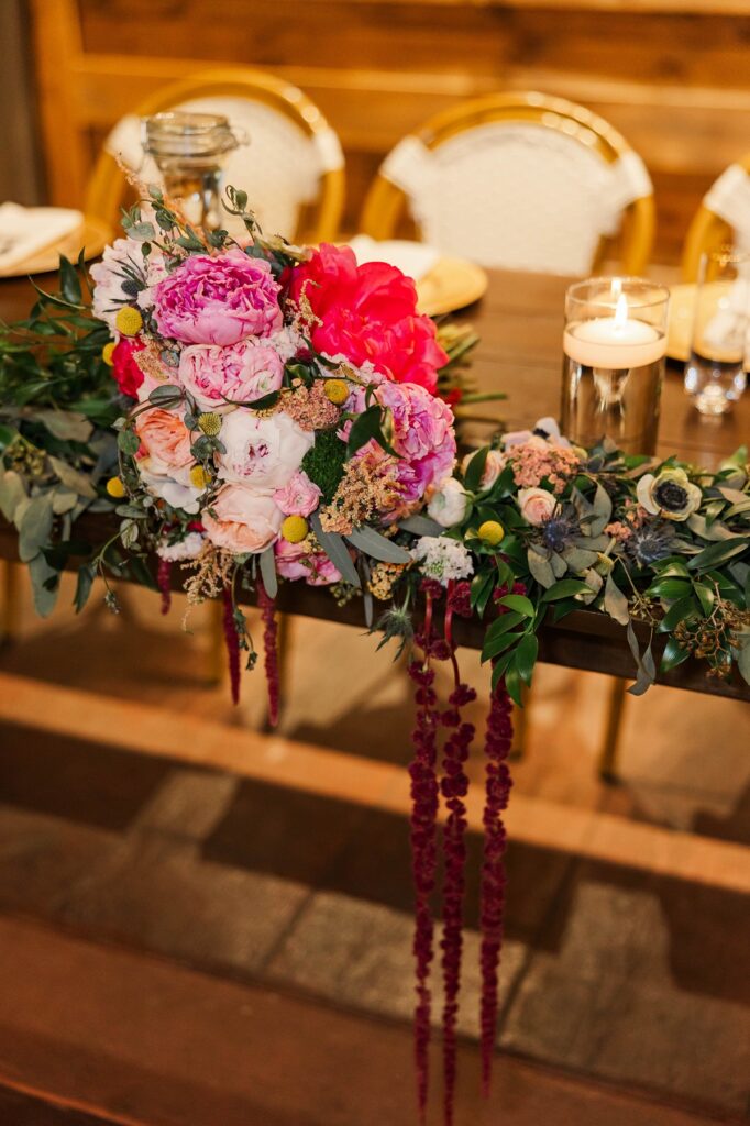 Head table floral design at BlueBridge Events Centre wedding venue near Traverse City Michigan