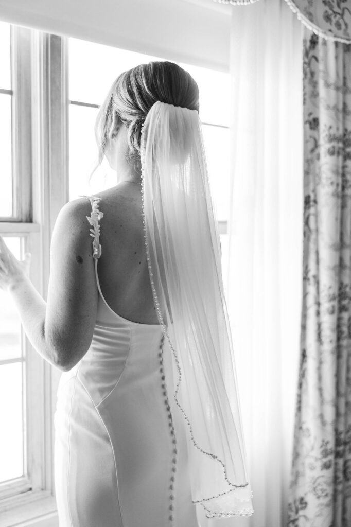 Bride in elegant gown and veil at estate-style window, inspired by a Greencrest Manor wedding