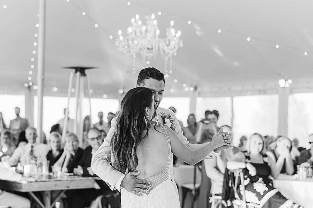 Bride and groom sharing their first dance at Bayview Weddings at Gallagher Farms in Cedar, Michigan during a luxury vineyard reception.