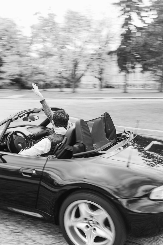 Couple driving convertible at State Hospital Grounds in Traverse City