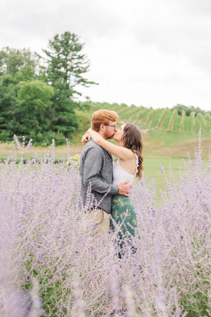 couple kissing in the Secret Garden at Brys Estate with vineyard views during a Northern Michigan portrait session