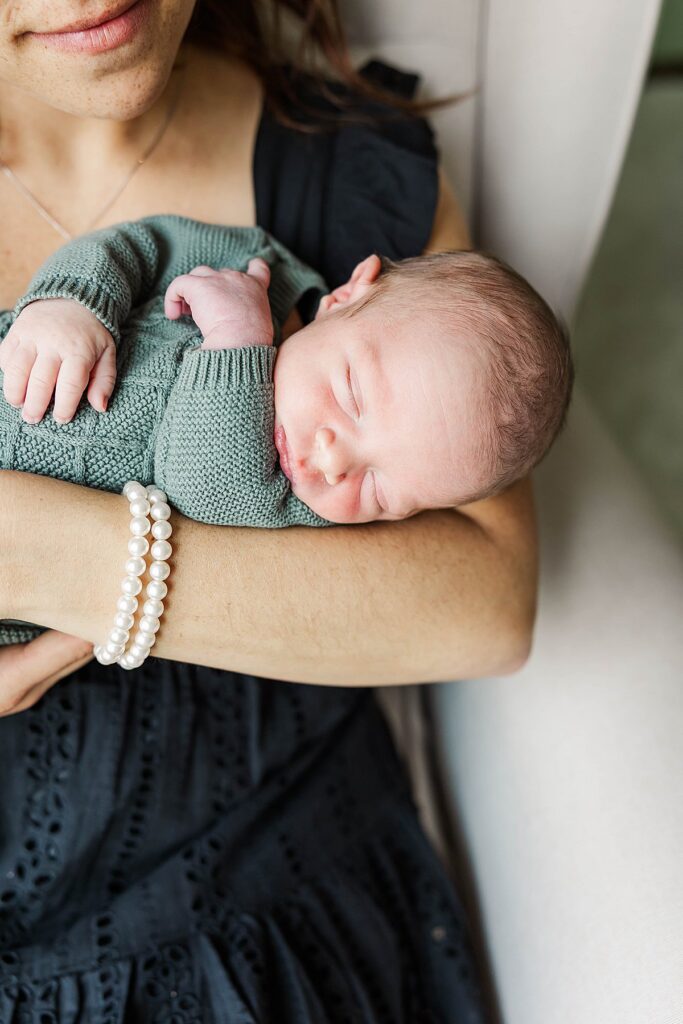 mom holding newborn baby during an in-home Northern Michigan portrait session