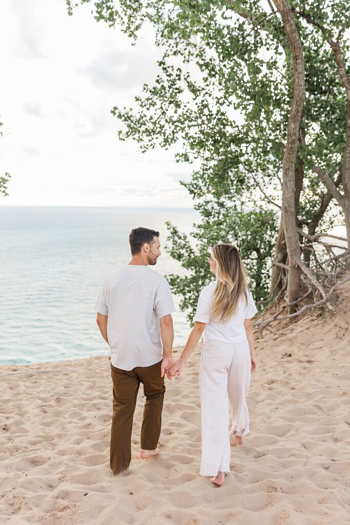 Northern Michigan couple portrait session walking on sand dunes near Lake Michigan