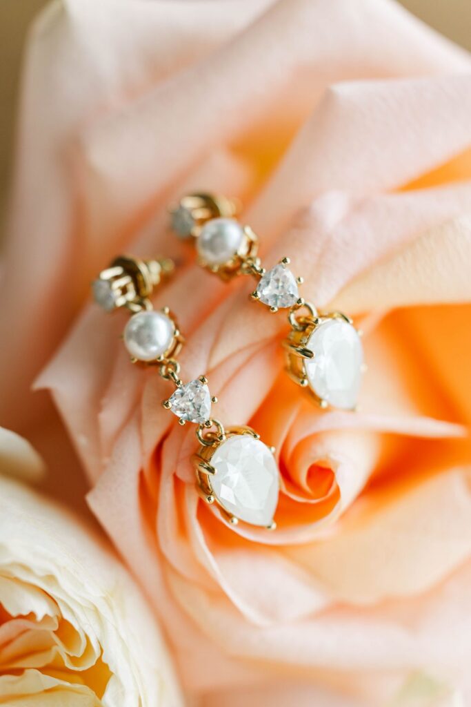 bridal earrings styled with rose for floral wedding detail photos