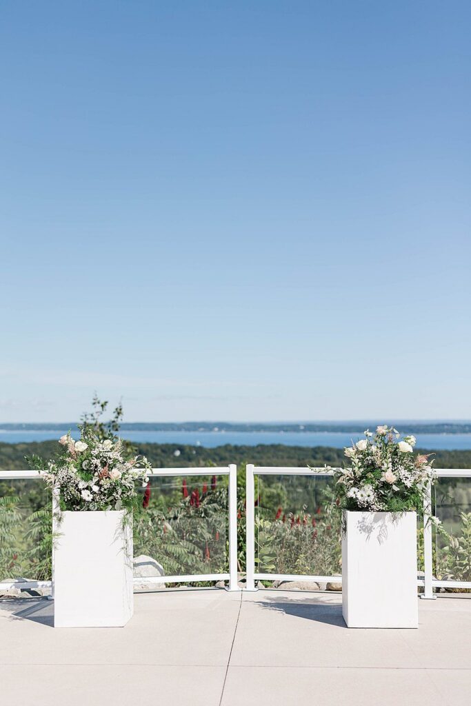 northern Michigan wedding ceremony florals overlooking the landscape at Bayview Weddings at Gallagher Farms