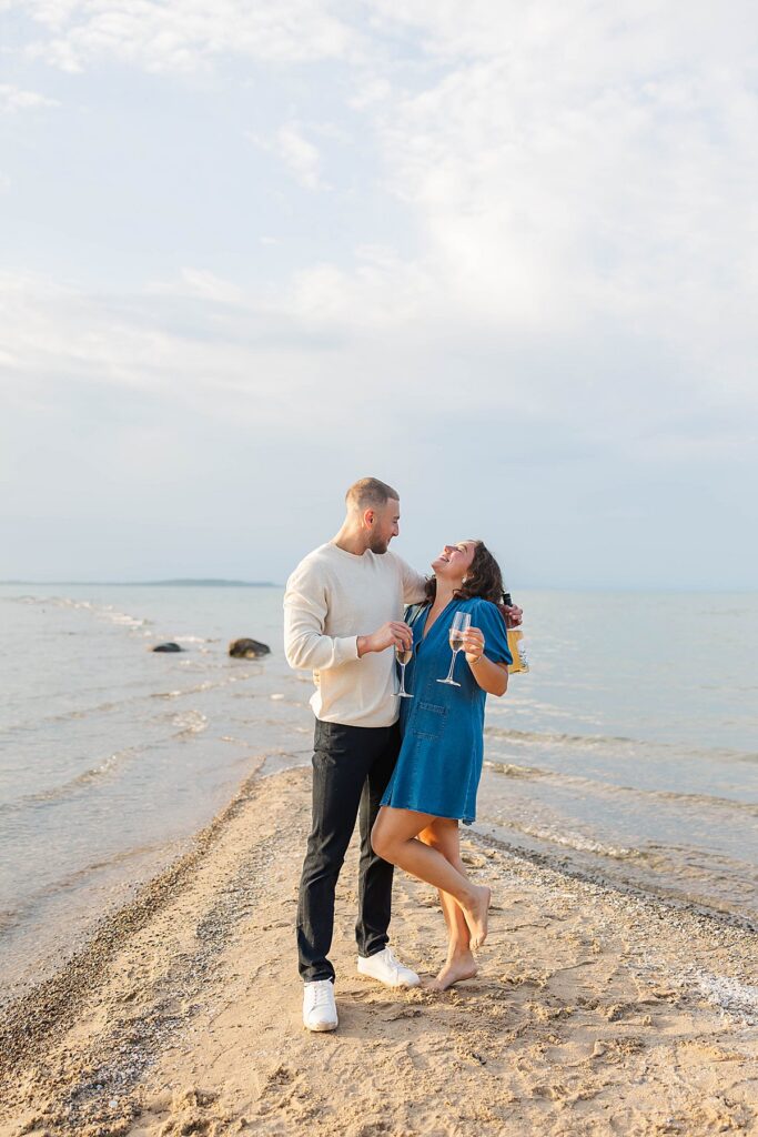 Couple celebrating on the beach during a Northern Michigan destination wedding weekend